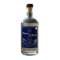 A bottle of Gin by Mergel & Route from VP Racing Spirits, featuring a dark blue label with white text and illustrations, sealed with a dark brown wooden stopper, on a plain white background.